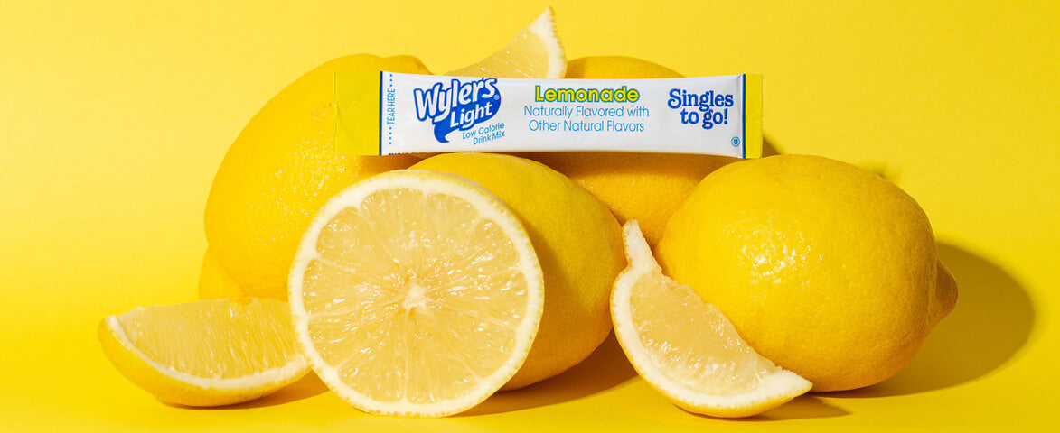 Lemonade Drinks, Wyler's Light Lemonade drink mix packet among fresh lemons on a yellow background