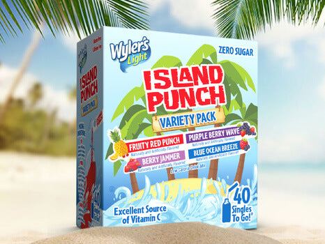 A box of Wylers Light Island Punch Variety Pack on a sandy beach with palm trees in the background, featuring flavors like Fruity Red Punch and Purple Berry Wave, indicating a zero sugar content and being an excellent source of Vitamin C